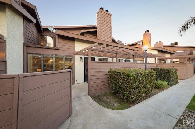 view of property exterior featuring a pergola