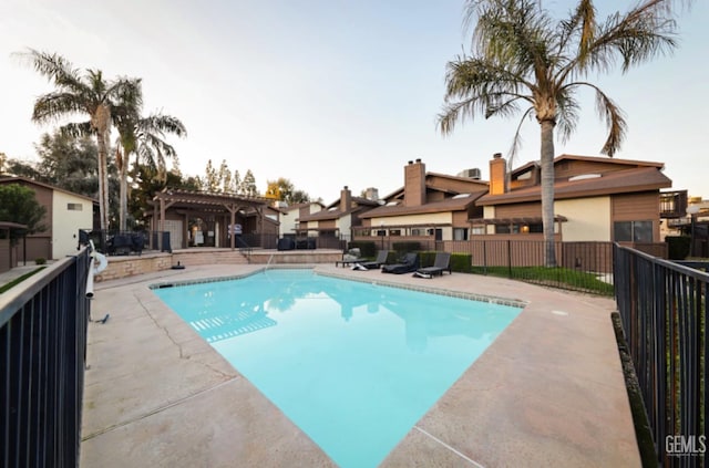 view of swimming pool with a patio and a pergola