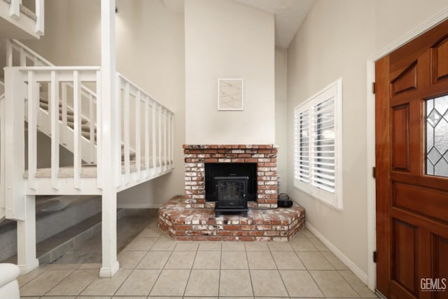 tiled entrance foyer with a wood stove