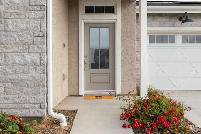 entrance to property with stucco siding