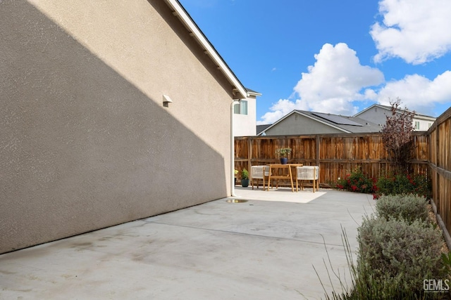 view of patio with a fenced backyard and outdoor dining area
