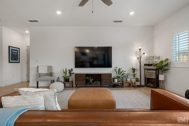 living room featuring recessed lighting, a ceiling fan, baseboards, and wood finished floors