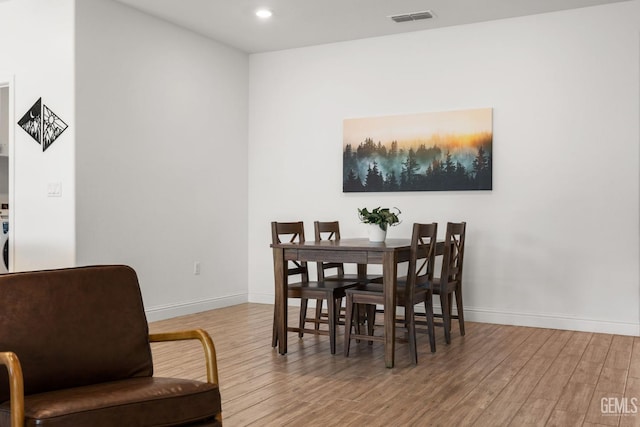 dining space featuring wood finished floors, baseboards, and recessed lighting