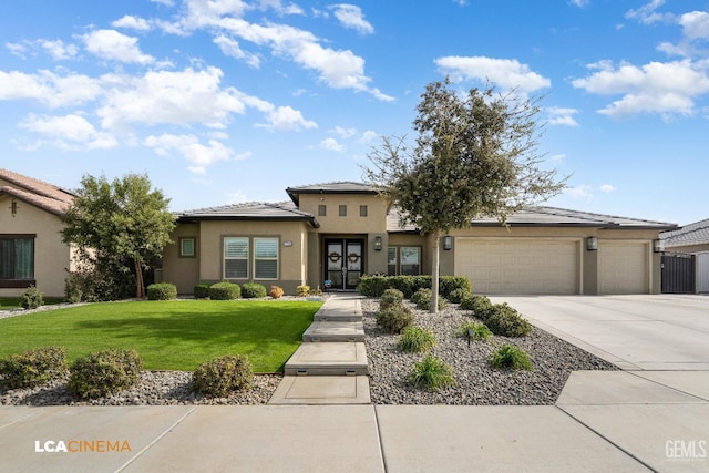 view of front of house with a garage and a front yard