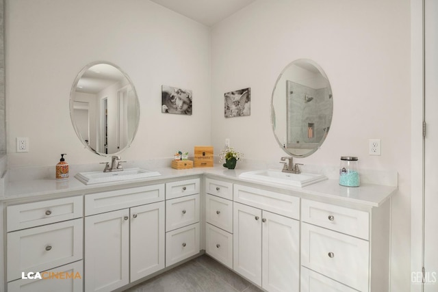 bathroom with a shower, tile patterned flooring, and vanity