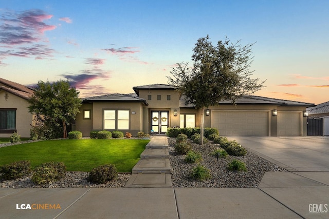 prairie-style house with a lawn and a garage