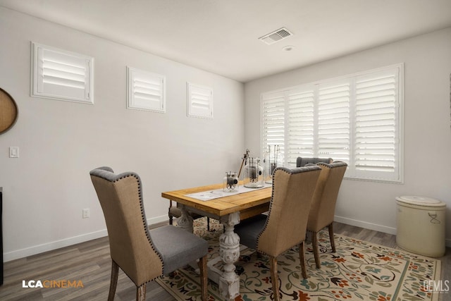 dining space with dark wood-type flooring