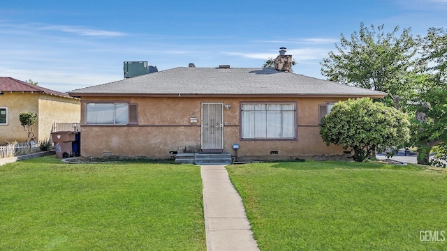 bungalow with central air condition unit and a front lawn