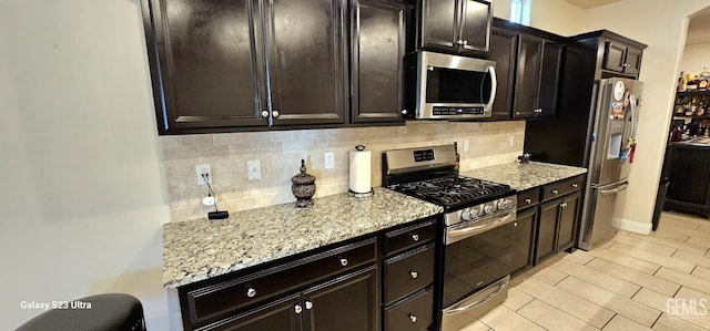 9211 Woodbrook Dr, Shafter, CA 93263 - kitchen featuring light stone countertops, tasteful backsplash, and appliances with stainless steel finishes