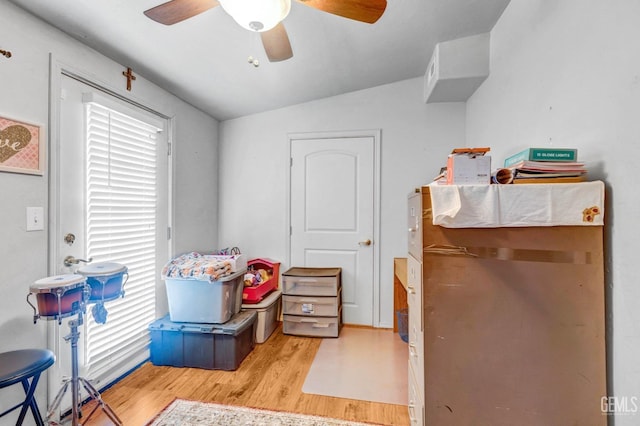 bedroom with vaulted ceiling, wood finished floors, and ceiling fan