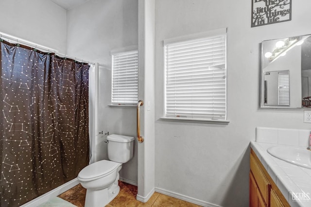 bathroom featuring toilet, curtained shower, tile patterned flooring, baseboards, and vanity