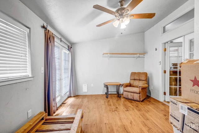 living area with light wood-style flooring and a ceiling fan