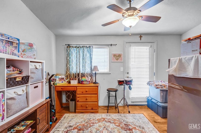 interior space with wood finished floors and ceiling fan