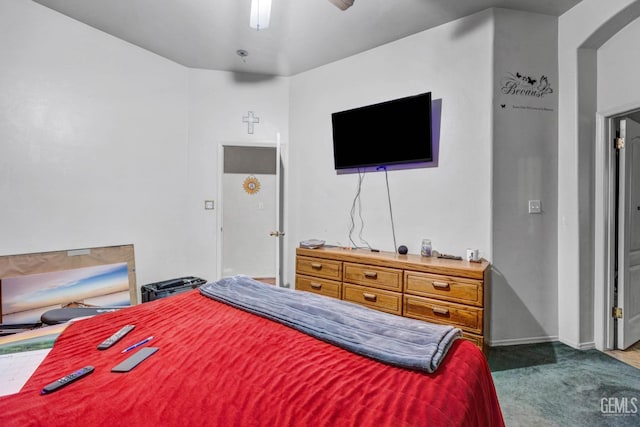 bedroom with carpet floors, arched walkways, and a ceiling fan