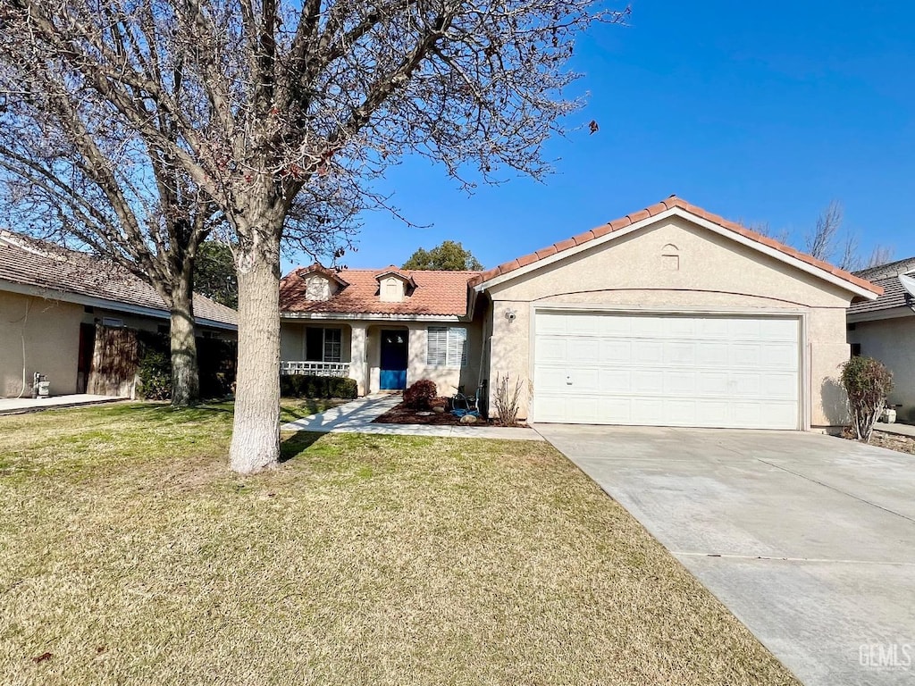 single story home featuring a garage and a front yard