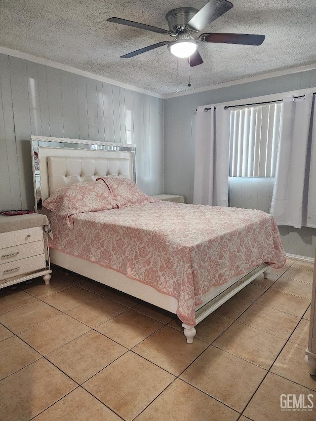 tiled bedroom with ceiling fan, wood walls, and a textured ceiling