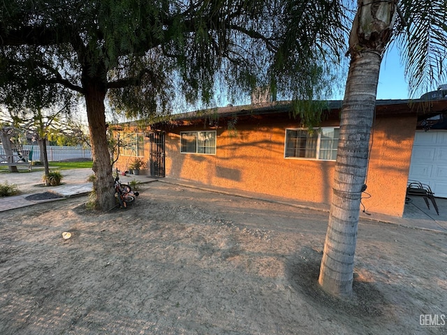 view of side of home featuring a garage