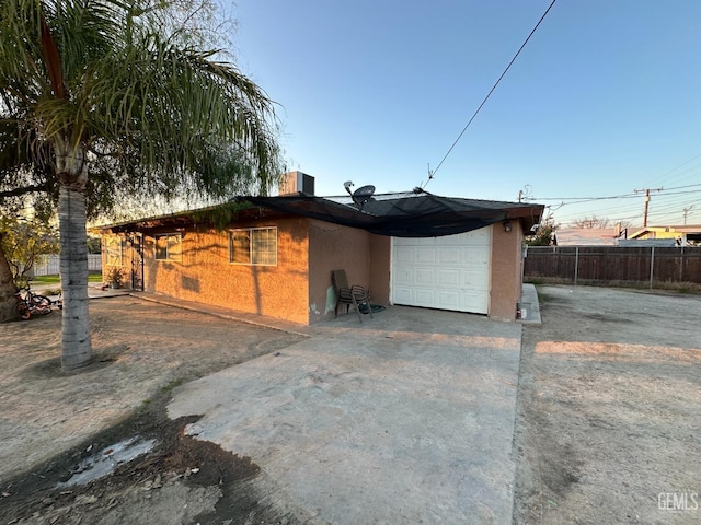 rear view of property featuring a garage