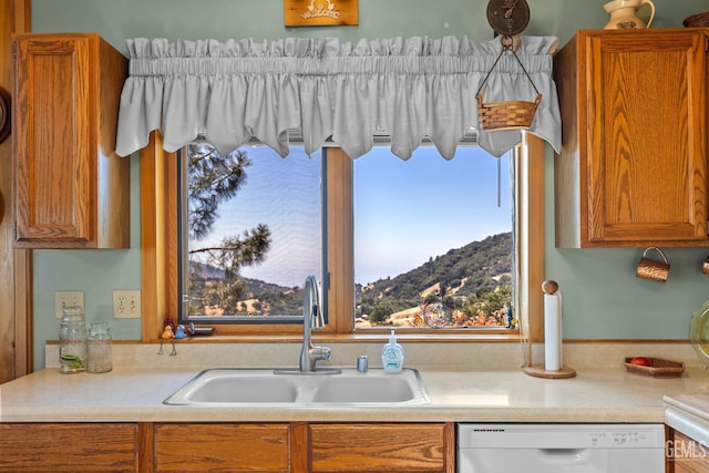 25001 Cannonero Ct, Tehachapi, CA 93561 - kitchen featuring dishwasher, brown cabinetry, light countertops, and a mountain view