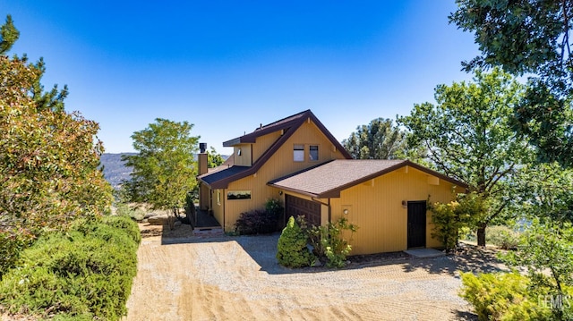 25001 Cannonero Ct, Tehachapi, CA 93561 - chalet / cabin featuring an attached garage, driveway, and a chimney