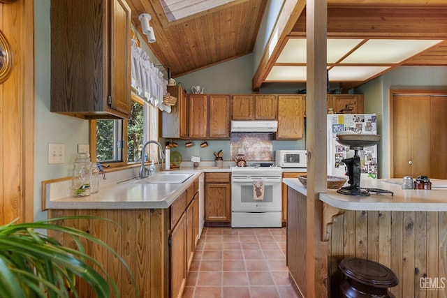 25001 Cannonero Ct, Tehachapi, CA 93561 - kitchen featuring white appliances, under cabinet range hood, light countertops, brown cabinetry, and light tile patterned floors
