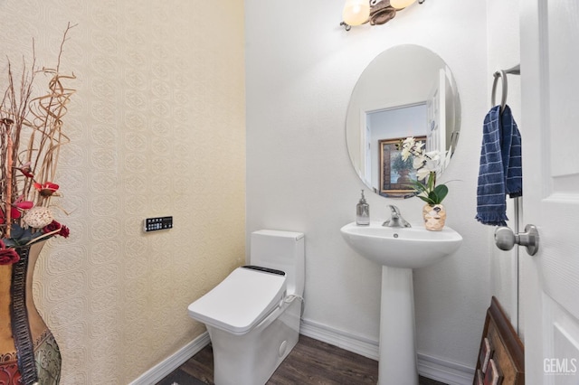 bathroom featuring hardwood / wood-style floors, sink, and toilet