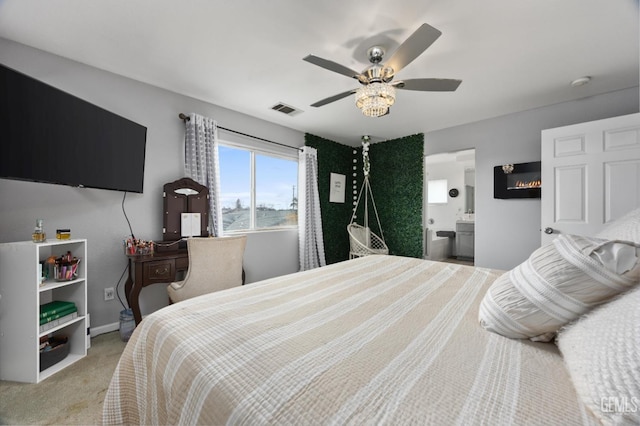 bedroom featuring ensuite bathroom, ceiling fan, and carpet flooring