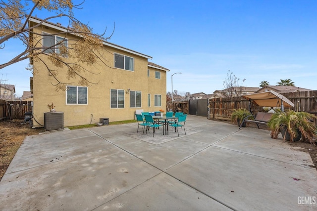 back of house featuring central AC unit and a patio area