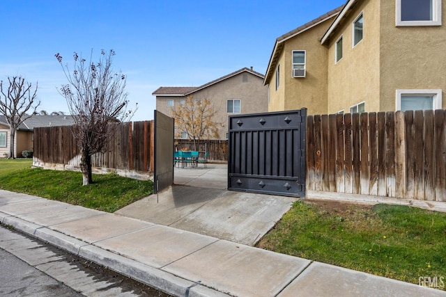 view of gate featuring a patio