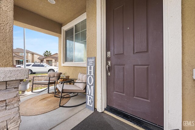 doorway to property featuring covered porch