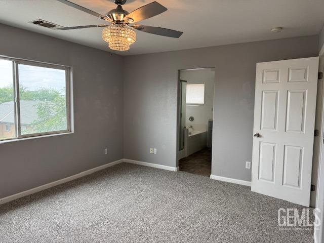 unfurnished bedroom with baseboards, visible vents, carpet flooring, and ceiling fan