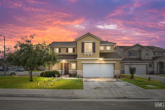 view of front of property featuring a garage and a yard