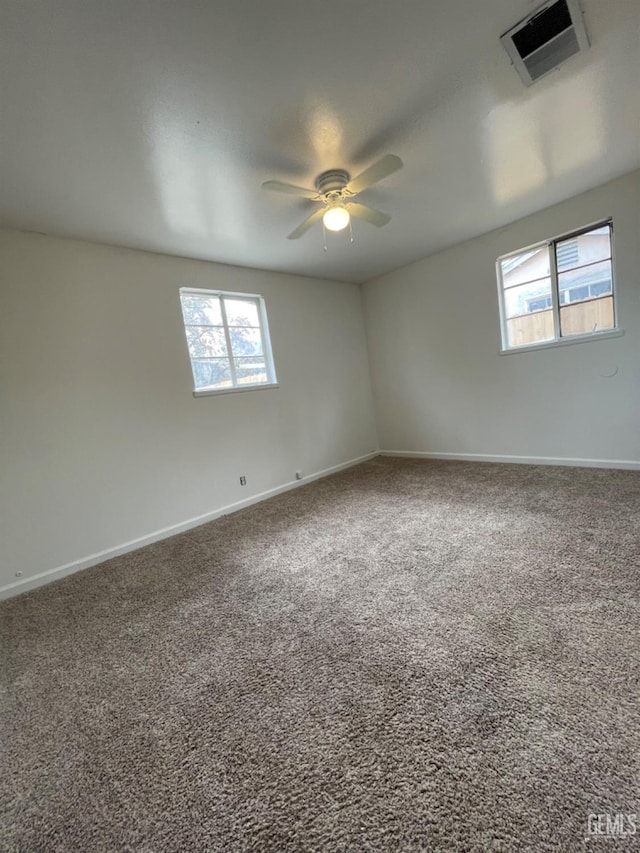 carpeted empty room featuring ceiling fan