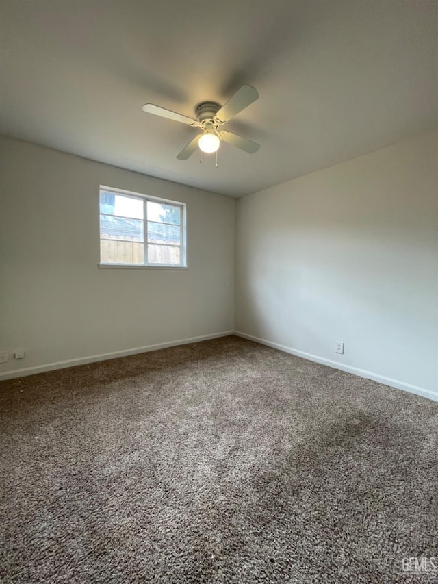 unfurnished room featuring ceiling fan and carpet floors