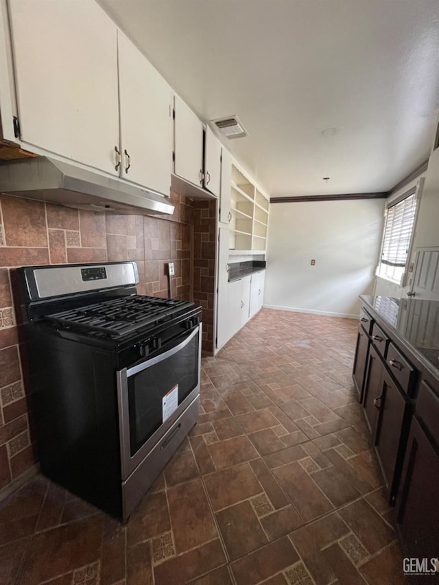 kitchen with white cabinets, ornamental molding, backsplash, and stainless steel range with gas stovetop