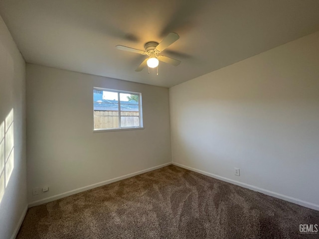 empty room with ceiling fan and carpet floors