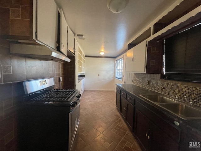 kitchen featuring white cabinets, black gas range oven, tasteful backsplash, and sink