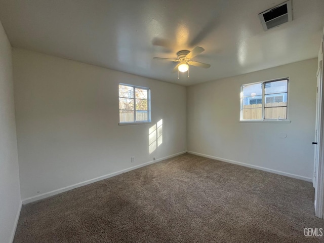 spare room with carpet flooring, ceiling fan, and a healthy amount of sunlight