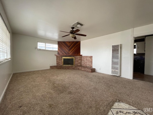 unfurnished living room featuring carpet flooring, ceiling fan, and a fireplace