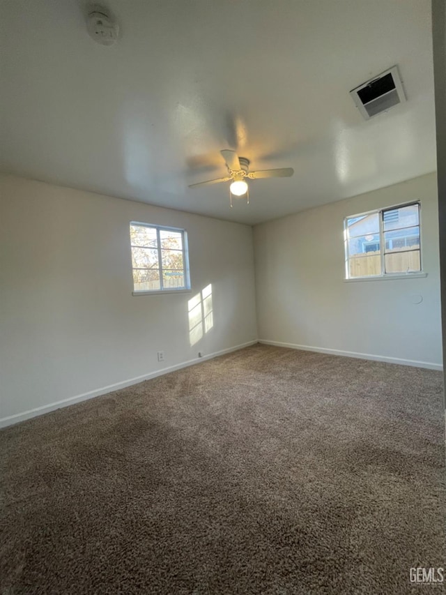 carpeted empty room featuring ceiling fan