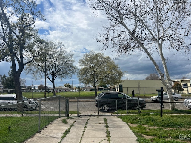 view of street featuring driveway and a gate