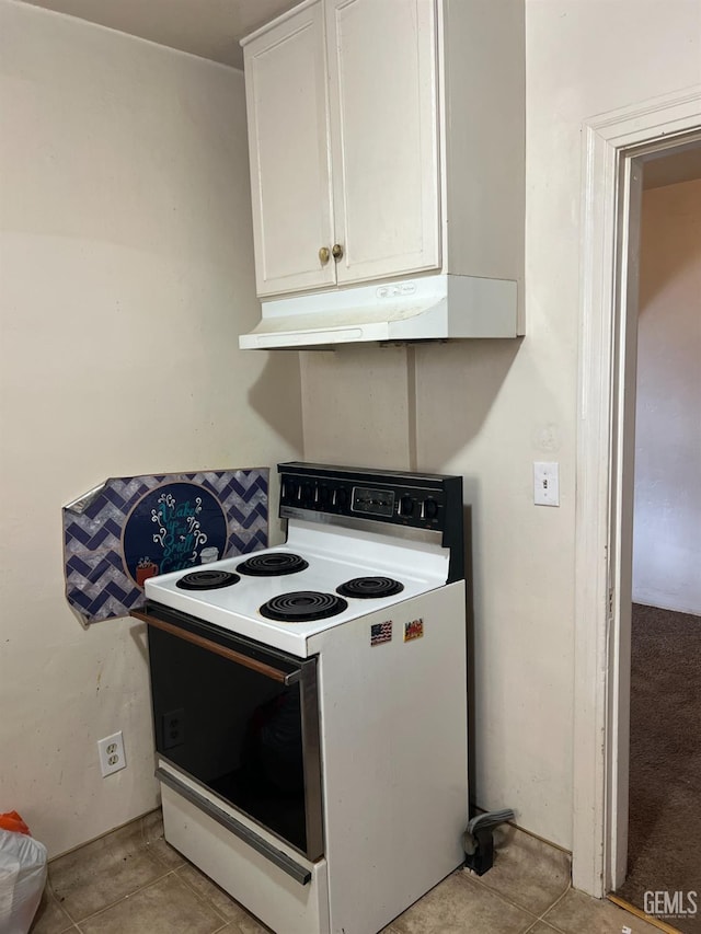 kitchen with under cabinet range hood, white cabinets, and electric stove