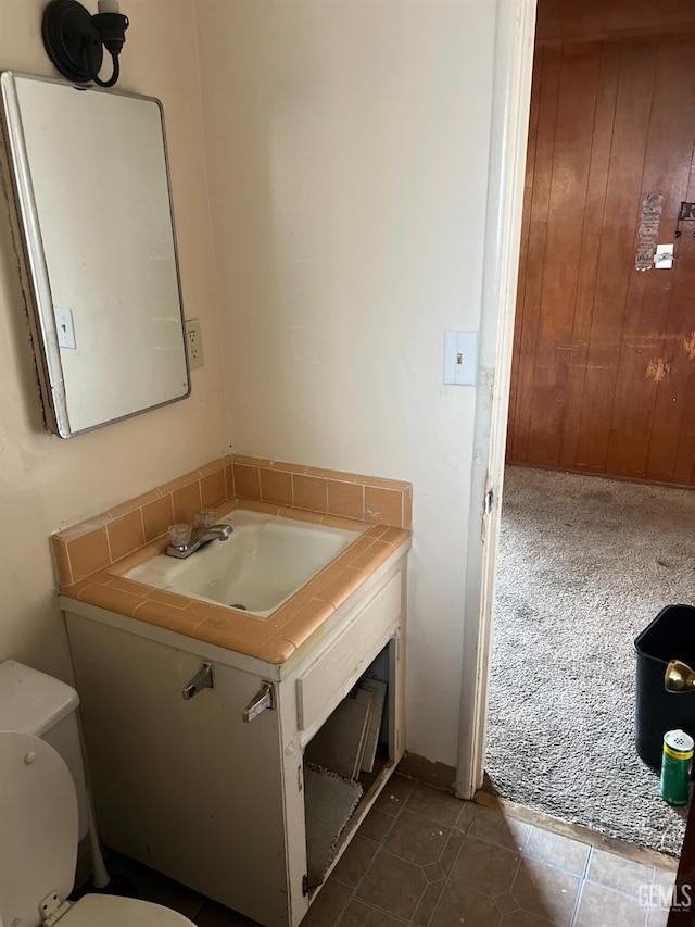 bathroom featuring tile patterned floors, toilet, and vanity