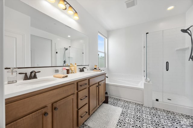 bathroom featuring tile patterned flooring, independent shower and bath, and vanity