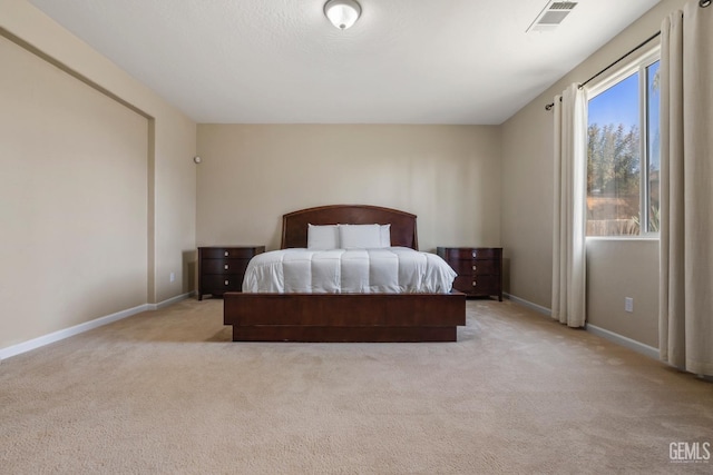 bedroom with light carpet, baseboards, and visible vents