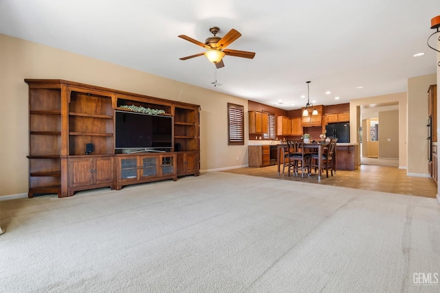 living area with light colored carpet, ceiling fan, baseboards, and recessed lighting