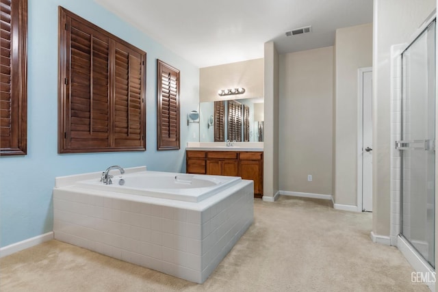 full bath with vanity, baseboards, a stall shower, visible vents, and a garden tub