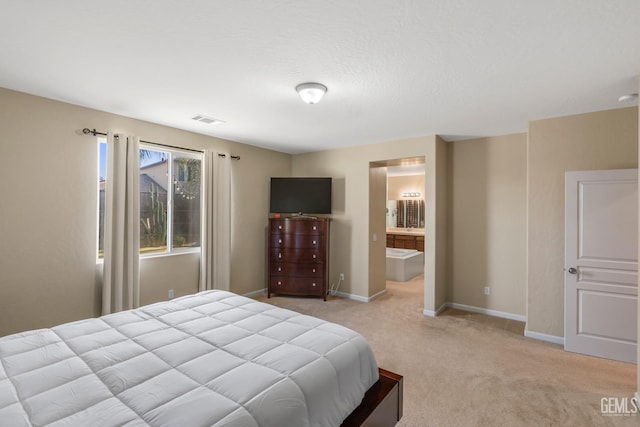 bedroom with light carpet, visible vents, baseboards, and connected bathroom