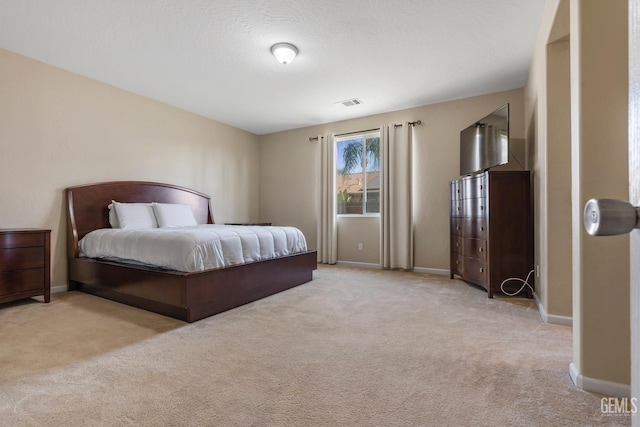 bedroom featuring light carpet, baseboards, and visible vents