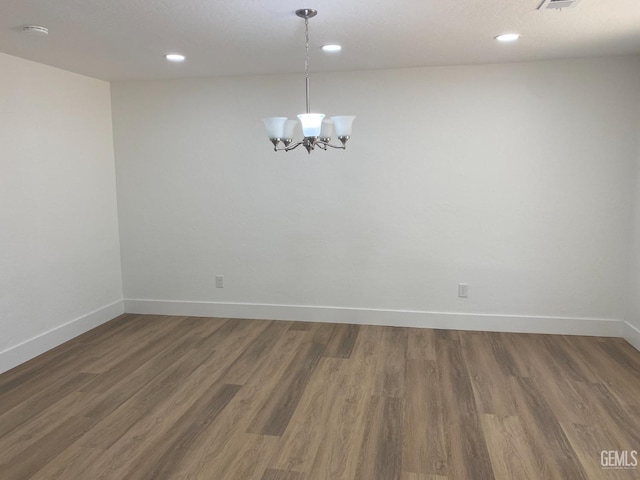 351 Adams St, Wasco, CA 93280 - spare room with baseboards, a chandelier, wood finished floors, recessed lighting, and a smoke detector